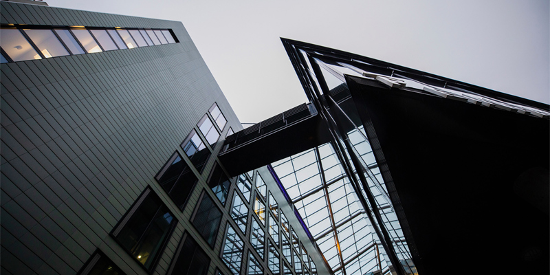 Looking up from the base of a modern building. Key takeaways from the first Building Safety Act remediation order—Property Week