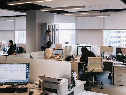 An office of workers working at their desks. Upcoming changes to UK business immigration law