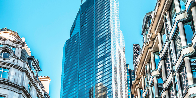 Traditional London buildings justaposed and overshawdowed by a high rise building. Developers left in the dark—Property Week