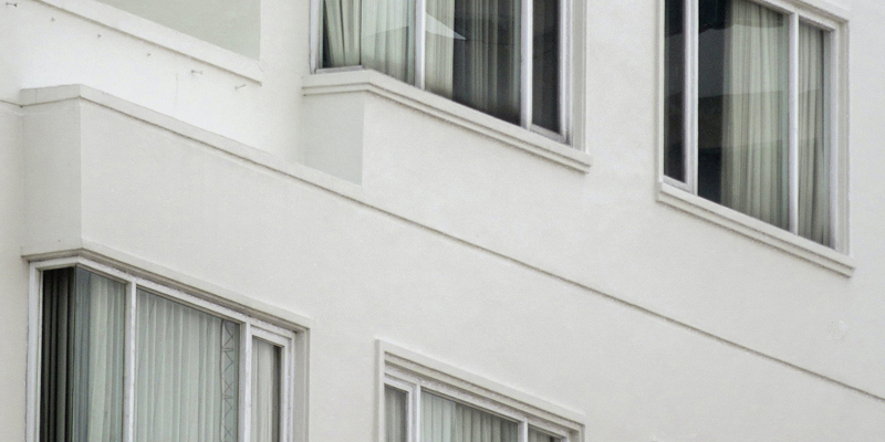 The exterior of a 1970's block of flats close up. How can I evict squatters from my property?—The Sunday Times