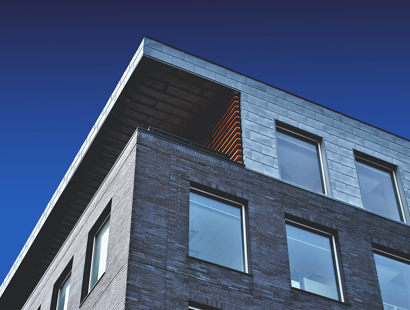 Can I stop smokers from buying a flat in my building?—The Times. The image shows an external facade of a modern residential building. 