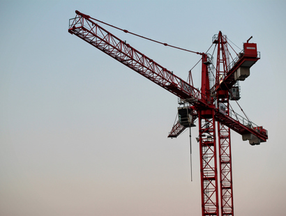 red crane in blue sky. Recent CIL appeal acts as reminder that obligation to pay CIL can be triggered by demolition