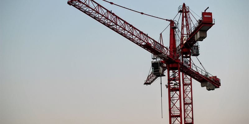 red crane in blue sky. Recent CIL appeal acts as reminder that obligation to pay CIL can be triggered by demolition