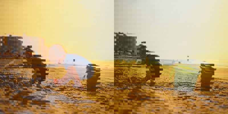 A child on a beach with a bucket and spade. Practical tips for travelling abroad after separation