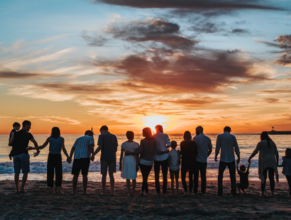 A huge family congregating on a beach for sunset. ¬Billions of pounds worth of assets remain unclaimed as it’s taboo to talk about death: let’s start the conversation