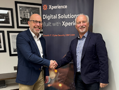 Iain O'Kane and Chris Harthman shake hands on a deal on the sale of GCC Group to Xperience. 