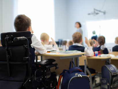 School boy in wheelchair at the back of a classroom. Equality Act Claims-Disability discrimination in schools
