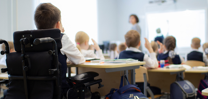 School boy in wheelchair at the back of a classroom. Equality Act Claims-Disability discrimination in schools