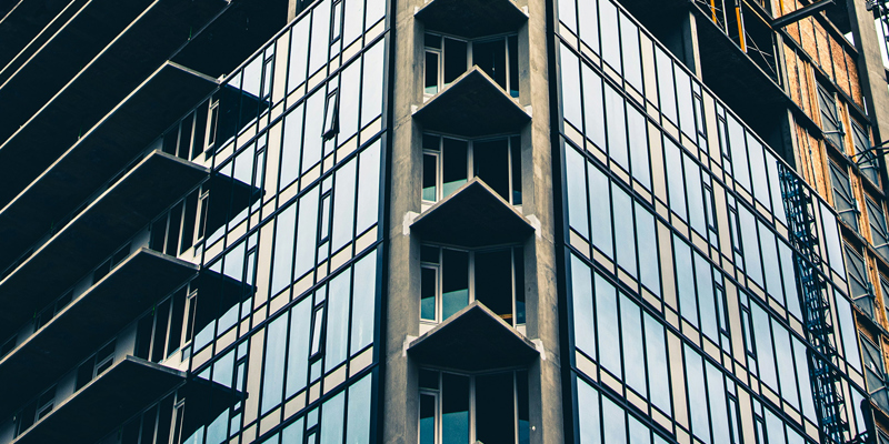 An exterior of a modern high rise residential building under construction. Binding decision on retrospectivity on the Building Safety Act