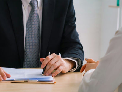 Lawyer looking at contract with client