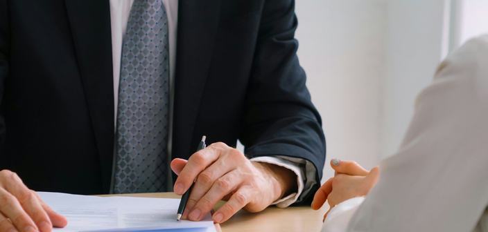 Lawyer looking at contract with client