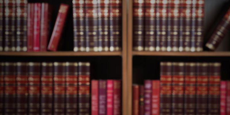 Law books stacked on a shelf. Family Procedure Rules.