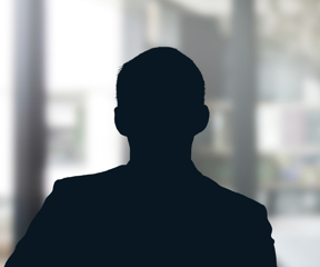 Russell-Cooke Solicitors staff photograph. Silhouette of a male team member against the backdrop of an office window with a soft focus effect.