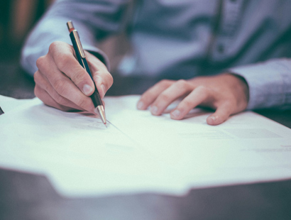 A man signing formal documents. Part 36 Offers: navigating the fine line between a ‘tactical’ offer and abuse of the regime—Solicitors Journal