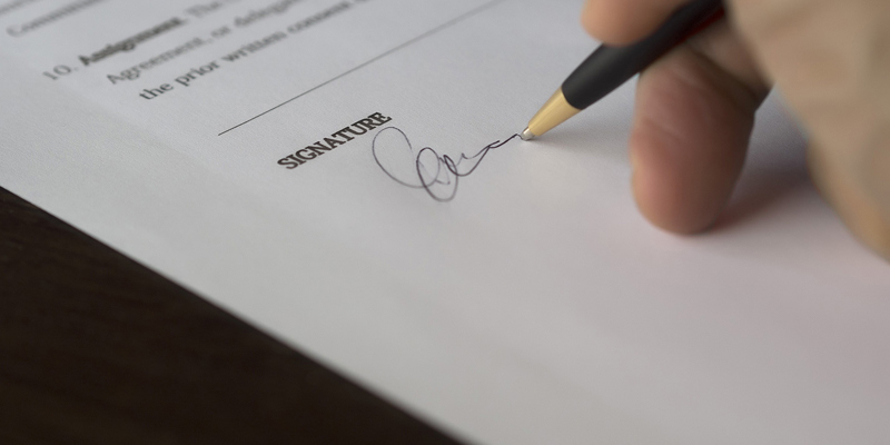 A person signing legal documentation. LPAs—stepping into the digital age with changes afoot 